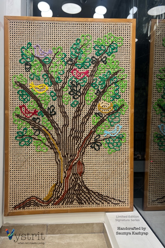 Modern Tree of Life: a tree drawn in brown and ochre thread line with scattered green leaves, each bird sitting alone on its own branch.